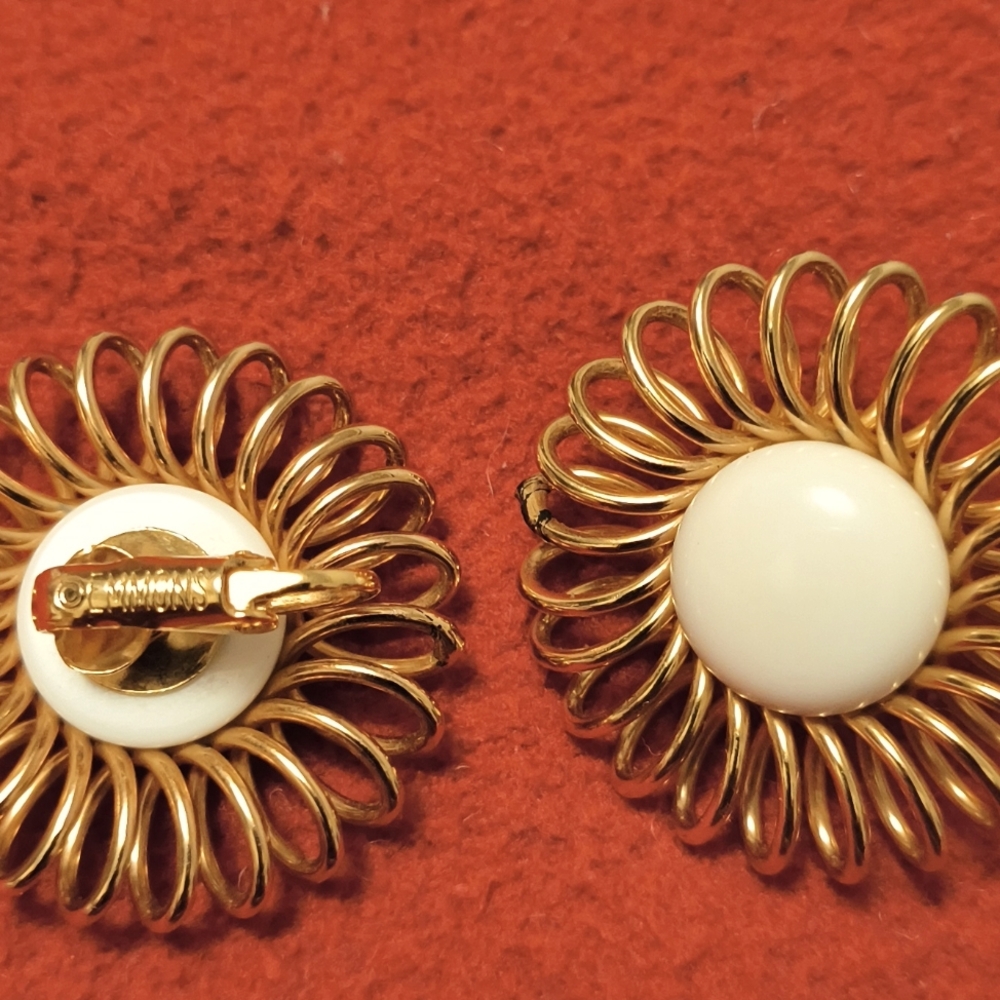 These are a signed pair of Monet spiral flour earrings gold tone.